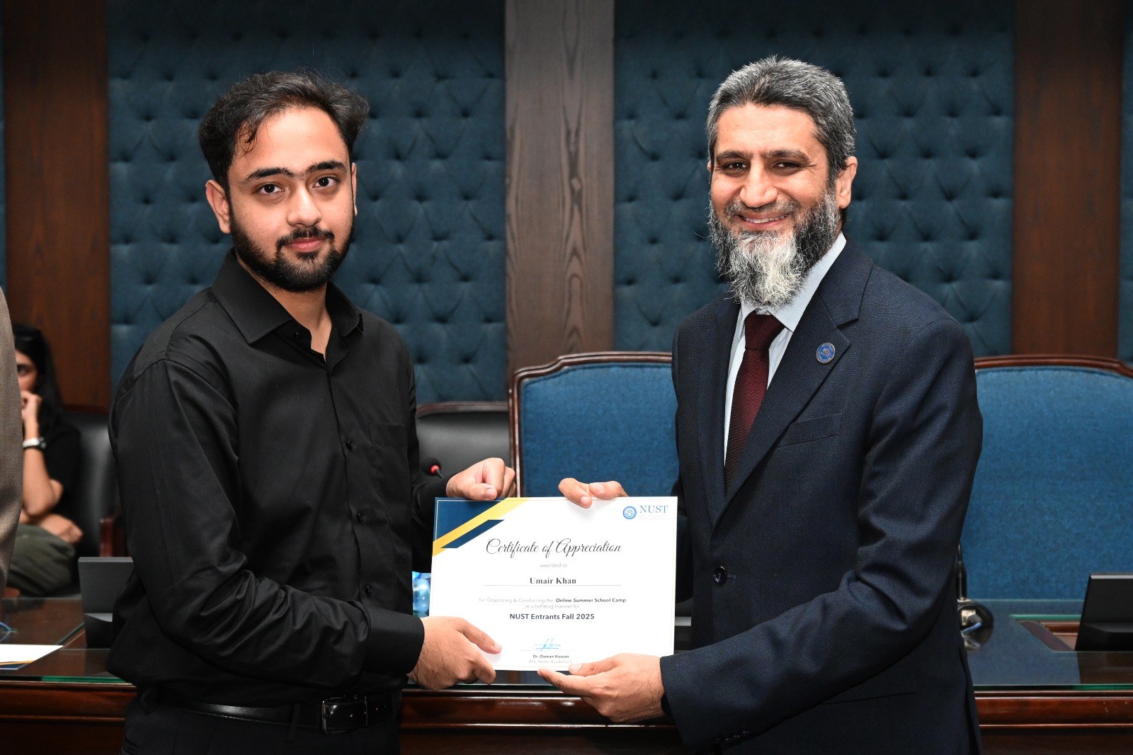 Certificate of Appreciation being presented to a participant at the in-person closing ceremony